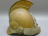 a helmet that has a golden helmet on top of it