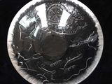 a silver plate with a picture of a man on it