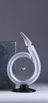 a glass sculpture of a swan with a diamond in its mouth