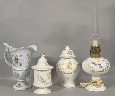 three vases, a lamp, and a vase on a table