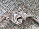 a close up of a decorative piece of art on a mosaic floor