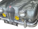 a silver car that is parked on the side of the road