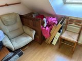 a chair and a table in a room with a skylight