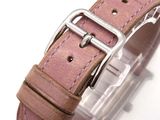 a close up of a watch on a white surface