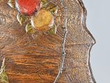 a close up of a wooden table with a flower on it