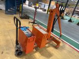 a small orange machine that is sitting in a warehouse