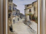 an oil painting of a street with buildings and flowers in a gold frame