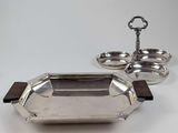 an antique silver plate with a wooden handle and a metal tray with a wooden handle