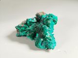 turquoise green crystals on a white plate on a white surface