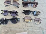several pairs of sunglasses are on a table with a price tag