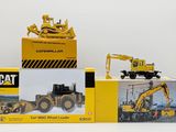 two boxed boxes of toy construction vehicles on a white surface