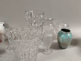 many glass vases sitting on a table next to each other