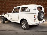 a white car that is parked in front of a brick wall