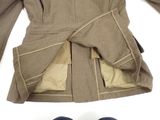 two pairs of shoes and a jacket on a white surface