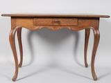 an old wooden table with a drawer on top of it