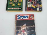 three comic books sitting on top of a table next to each other