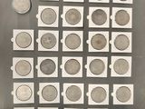 a close up of a bunch of coins on a table next to a coin