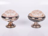 two silver vases that are sitting on a white surface