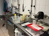 a kitchen with a sink and a counter with a lot of dishes