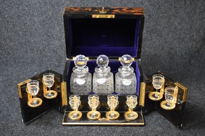 une photo représentant un lot de six carafes en verre dans un coffret en bois