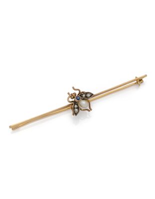 a close up of a gold and pearl insect broochle