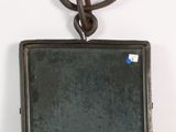 a small metal object hanging on the wall