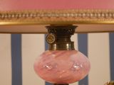 a lamp that has a pink glass shade on it