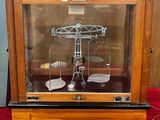a glass display case with a clock inside of it