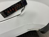 a close up of a car ' s bumper with a ruler on it