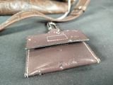 a brown purse and a brown wallet on a table