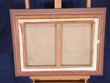 painting on easel with canvas and wooden frame on blue background