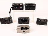 four different types of cameras on display on a white surface