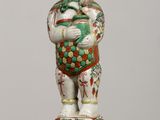 a figurine of a man holding a pot