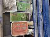 a metal box filled with assorted items on the floor