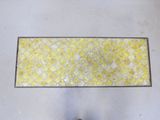 a person standing in front of a yellow and white tile floor