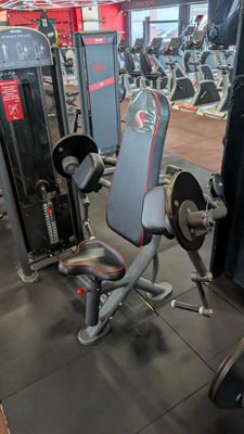 a gym room with a bench, weights, and other equipment
