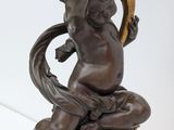 an image of a statue of a woman holding a bird