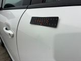 a sticker on the door of a white car