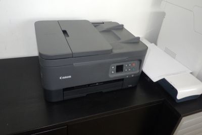 une imprimante posée sur un bureau à côté d'une imprimante