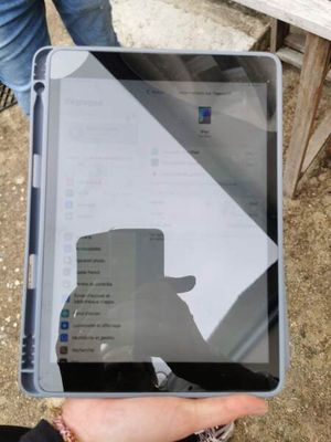 a person holding a tablet computer in their hand
