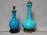 two blue vases sitting next to each other on a table