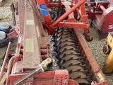 an image of a tractor and a plow in a yard
