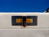 a close up of a white leather handbag with a gold buckle