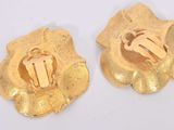 two pieces of gold colored metal with a design on them