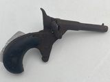 an old gun that is laying on a table