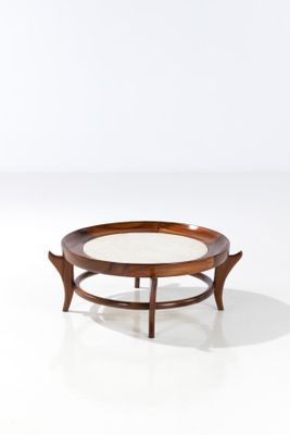 a round coffee table with a glass top on a white surface