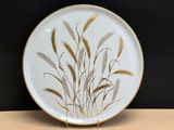 an image of a decorative plate with wheat on it on a table
