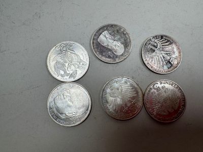 four quarters of silver coins sitting on top of a table