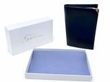 two black and white boxes with a blue cover and a white box