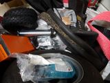 a pile of assorted items that include a tire, a cell phone, and other items